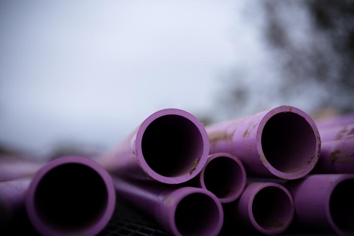 a short stack of purple PVC pipes